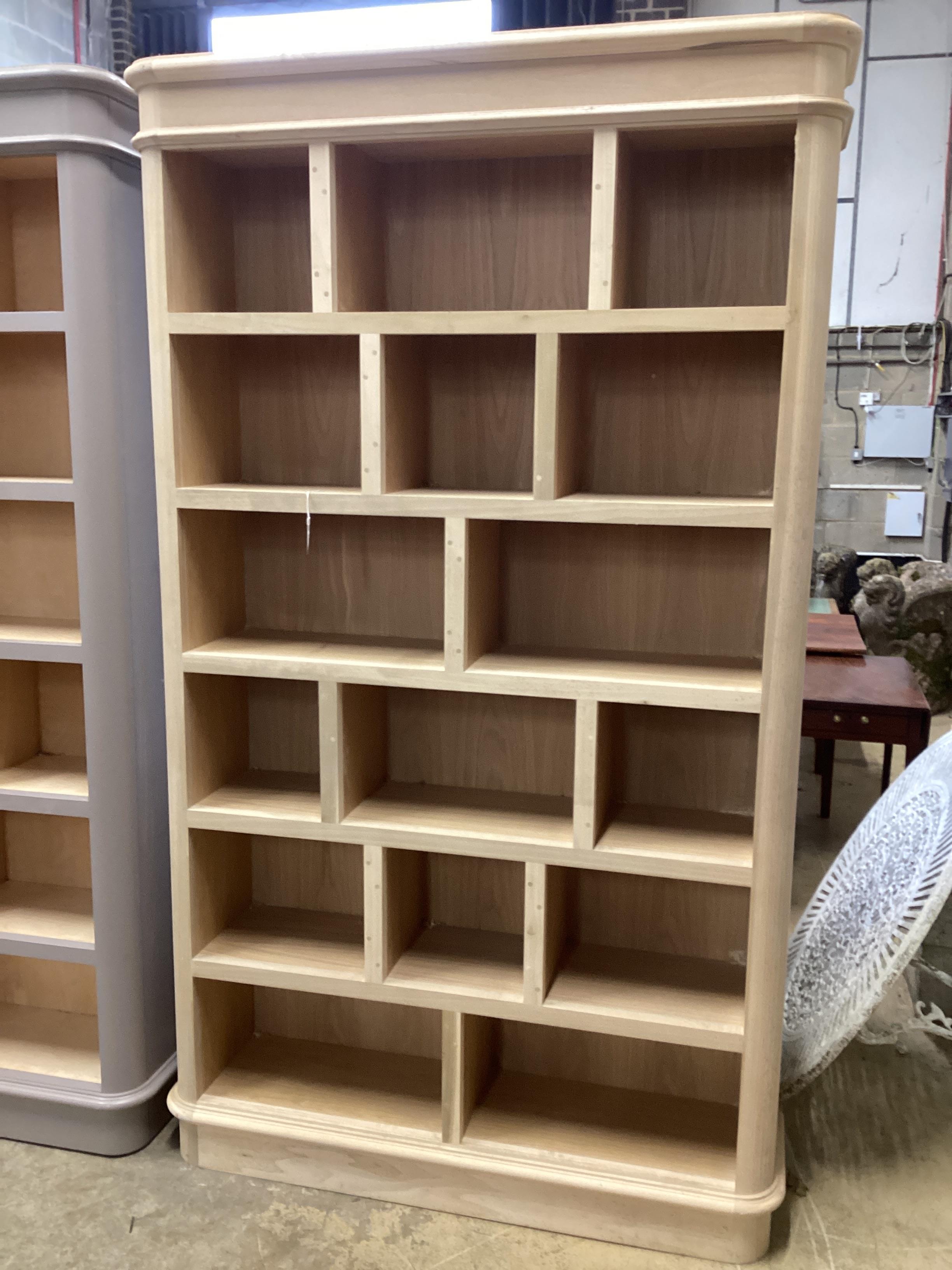 A contemporary oak veneered open wall unit by Inglis Hall, width 138cm, depth 36cm, height 231cm, Lewes RRP £3800